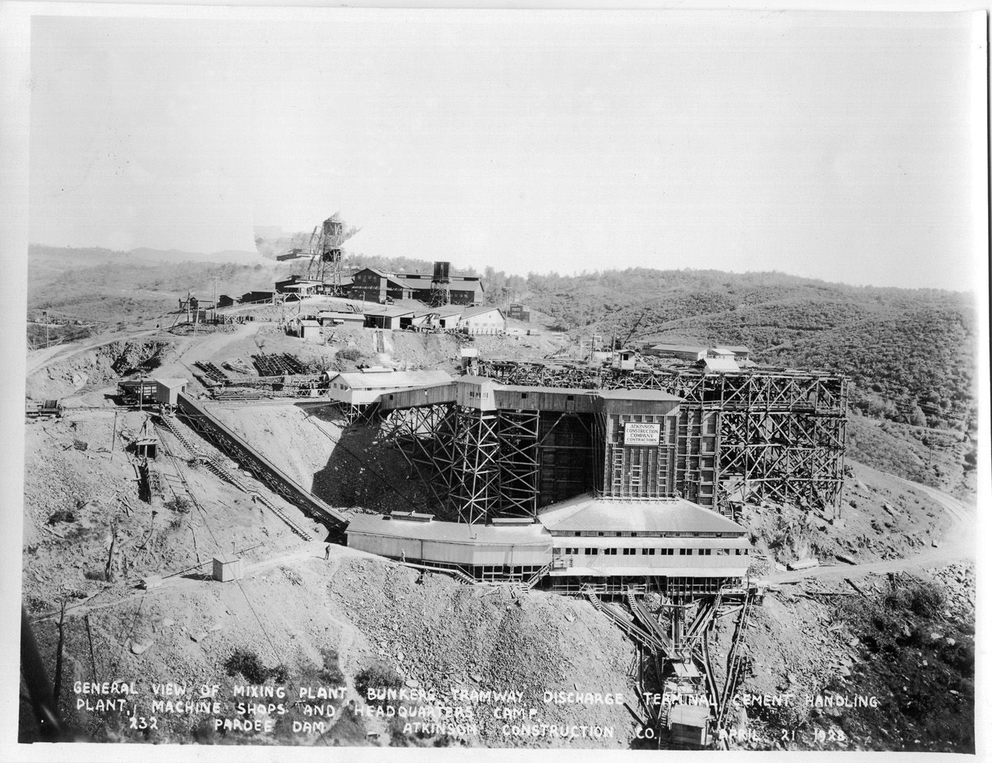 General view of mixing plant bunkers tramway discharge terminal cement handling plant, machine shops and headquarters camp.	(April 1928)