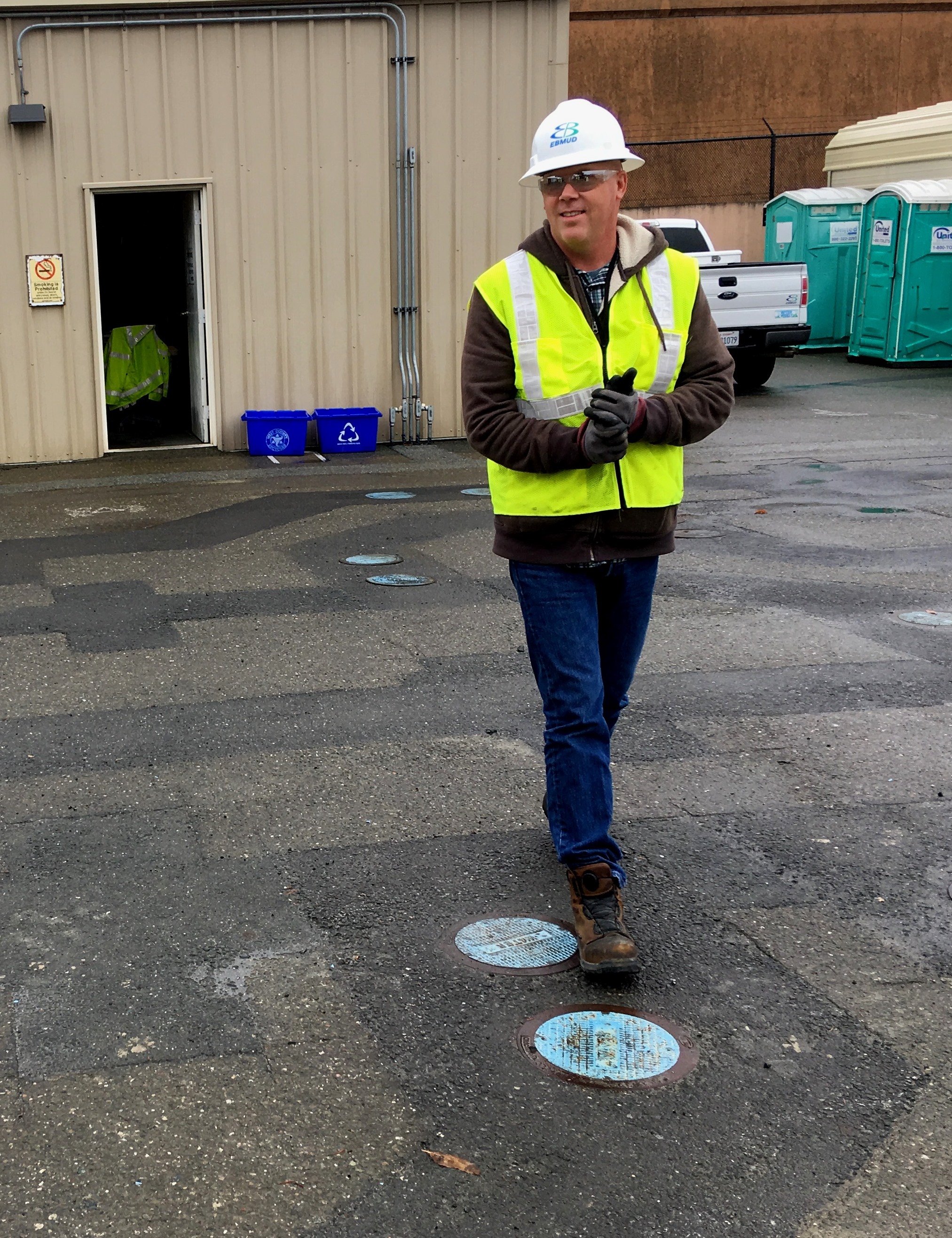 Adam oversees practice pipeline installations which have left a maze of pavement patches outside the academy.