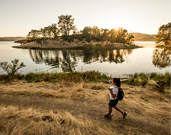 A hiker enjoys a sunrise at Pardee Reservoir.