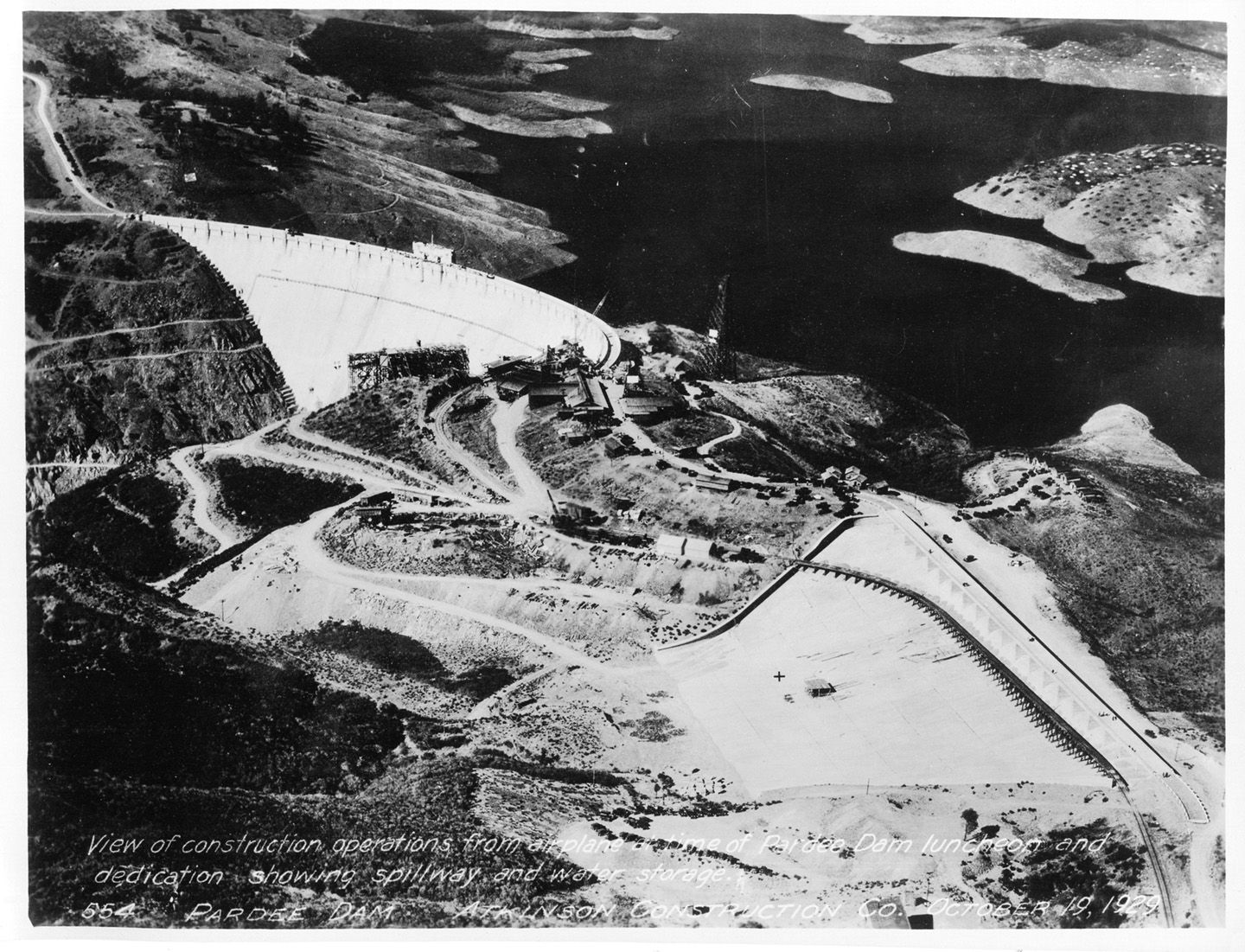 View of construction operations from airplane at time of Pardee Dam luncheon and dedication showing spillway and water storage. (October 1929)	