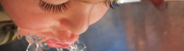 Child Drinks From Fountain