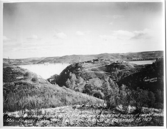 Panorama showing downstream face of dam powerhouse and spillway at completion. (December 1929)