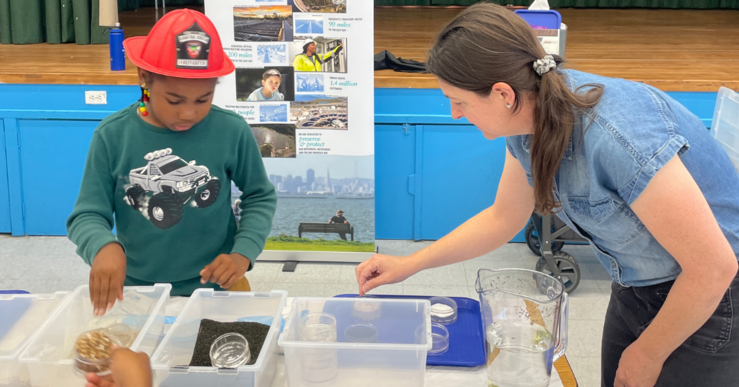 Teacher demonstrates filtration model to student