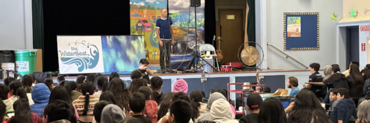 Photo of school assembly by Zun Zun "The Water Beat"
